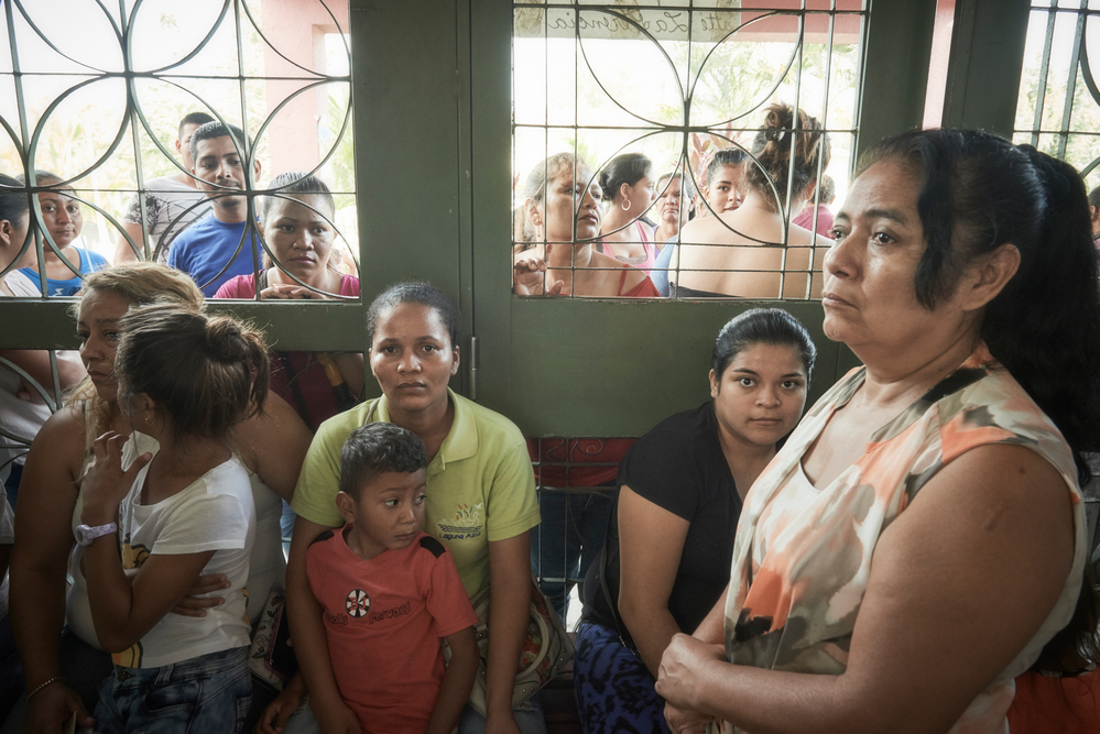 Women and children wait to be seen at an MSF clinic in Choloma.