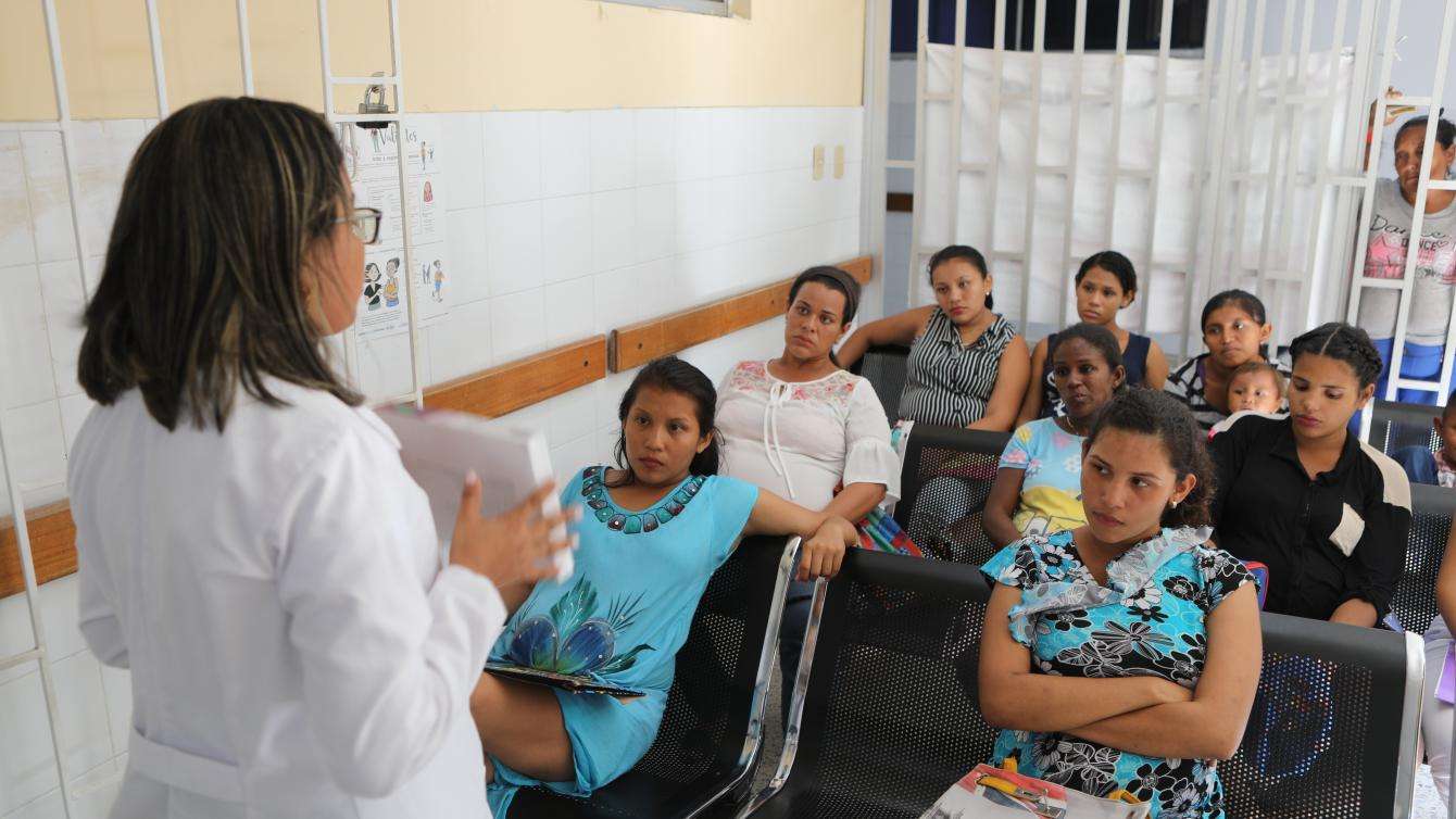 Woman talking to a group of people