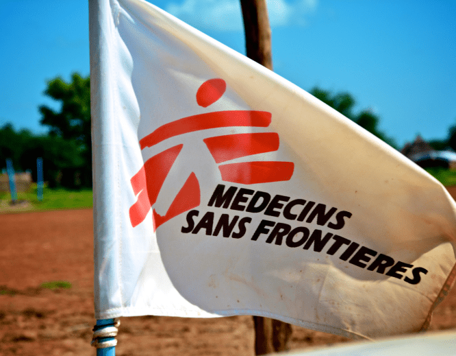 A white flag bearing MSF's logo