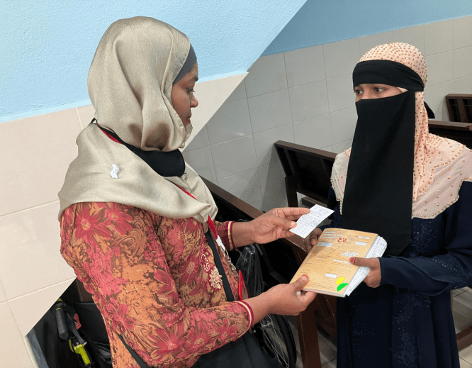 A Rohingya woman volunteer talks to a patient at Klinik Mewah 6 in Butterworth, Penang State, Malaysia.