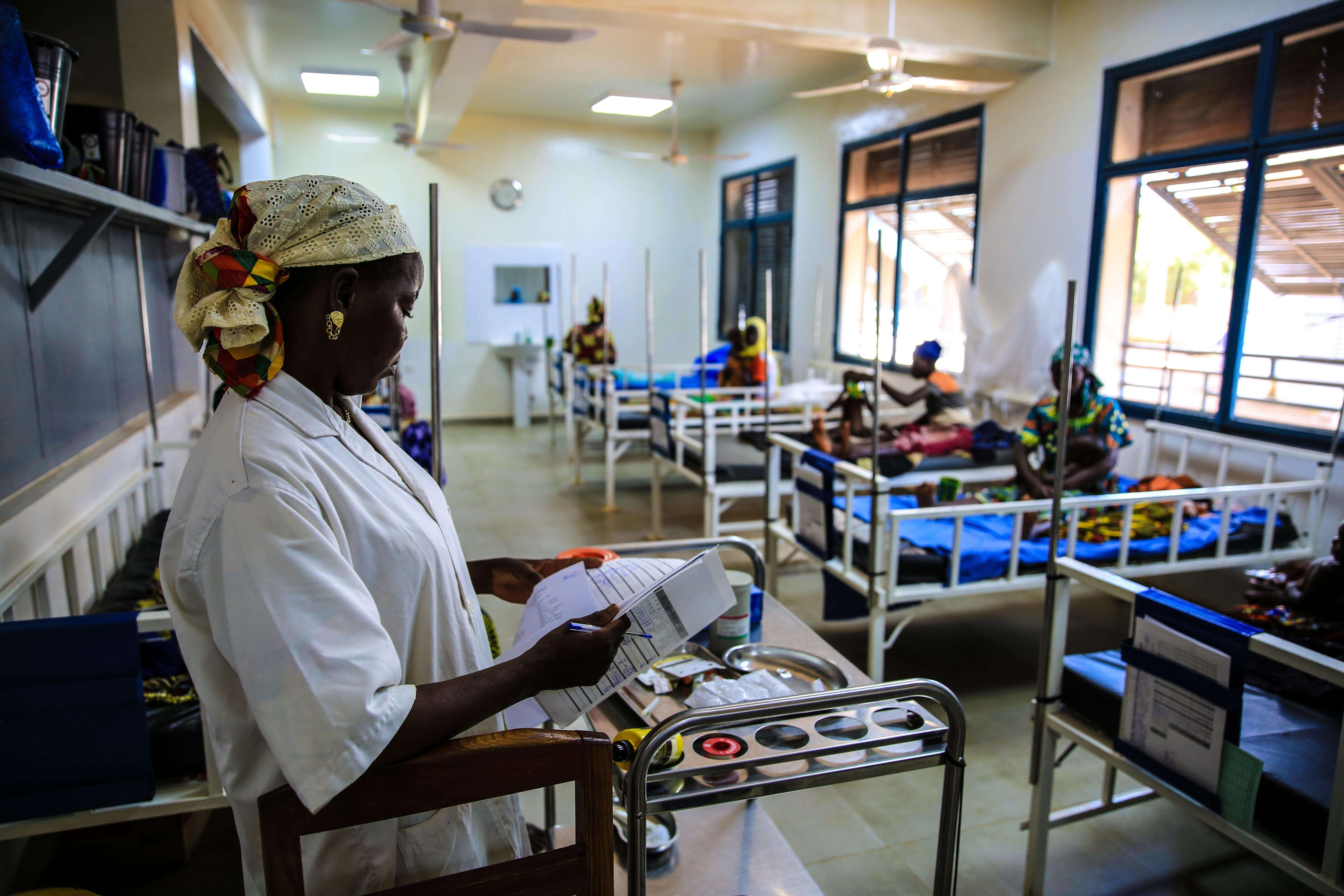  An MSF nurse checks the ﬁle of a child being treated for malnutrition