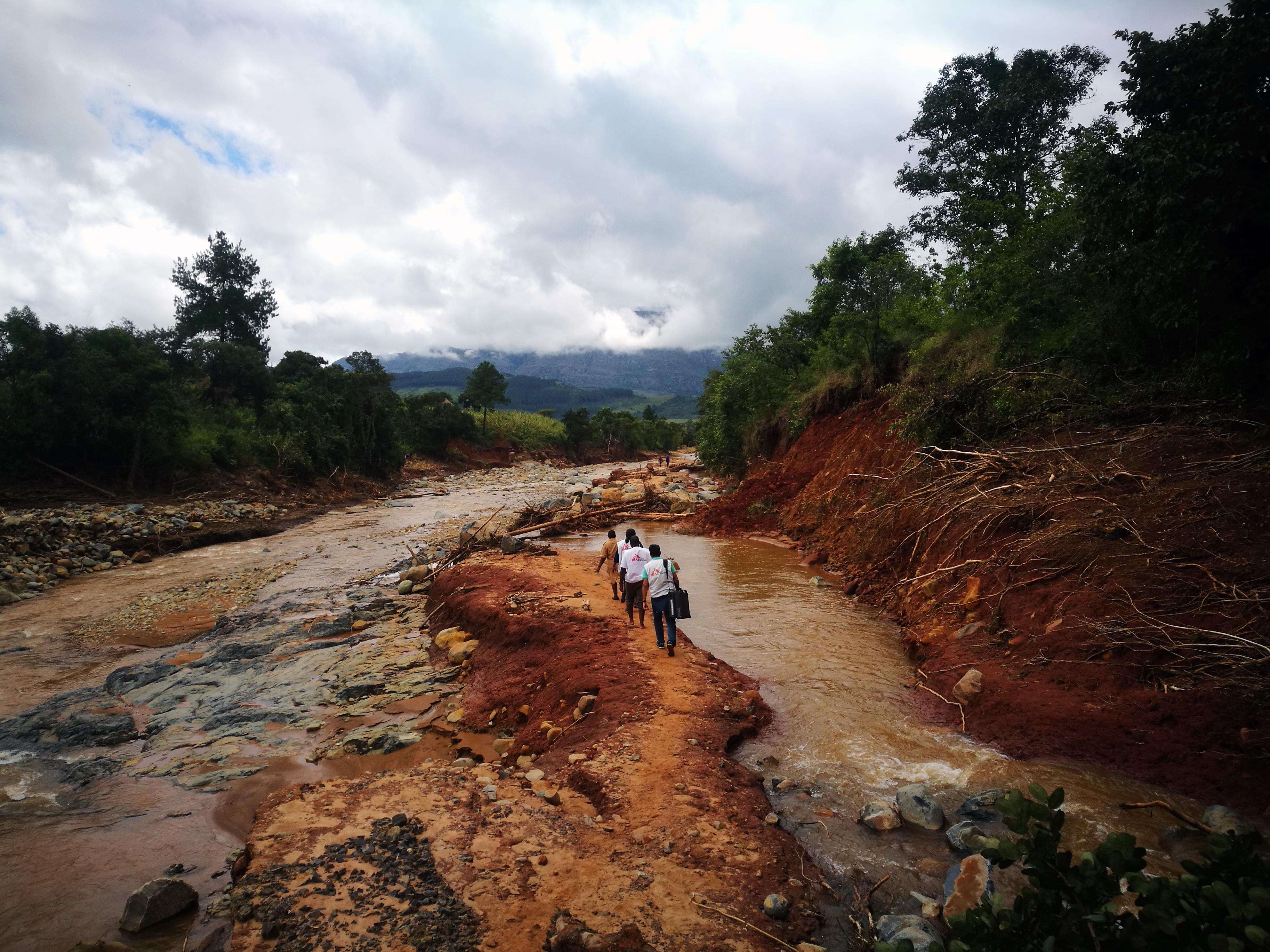 An MSF mobile team walks to access a village cut off by damage caused by Cylone Idai in Chimanimani, Zimbabwe.