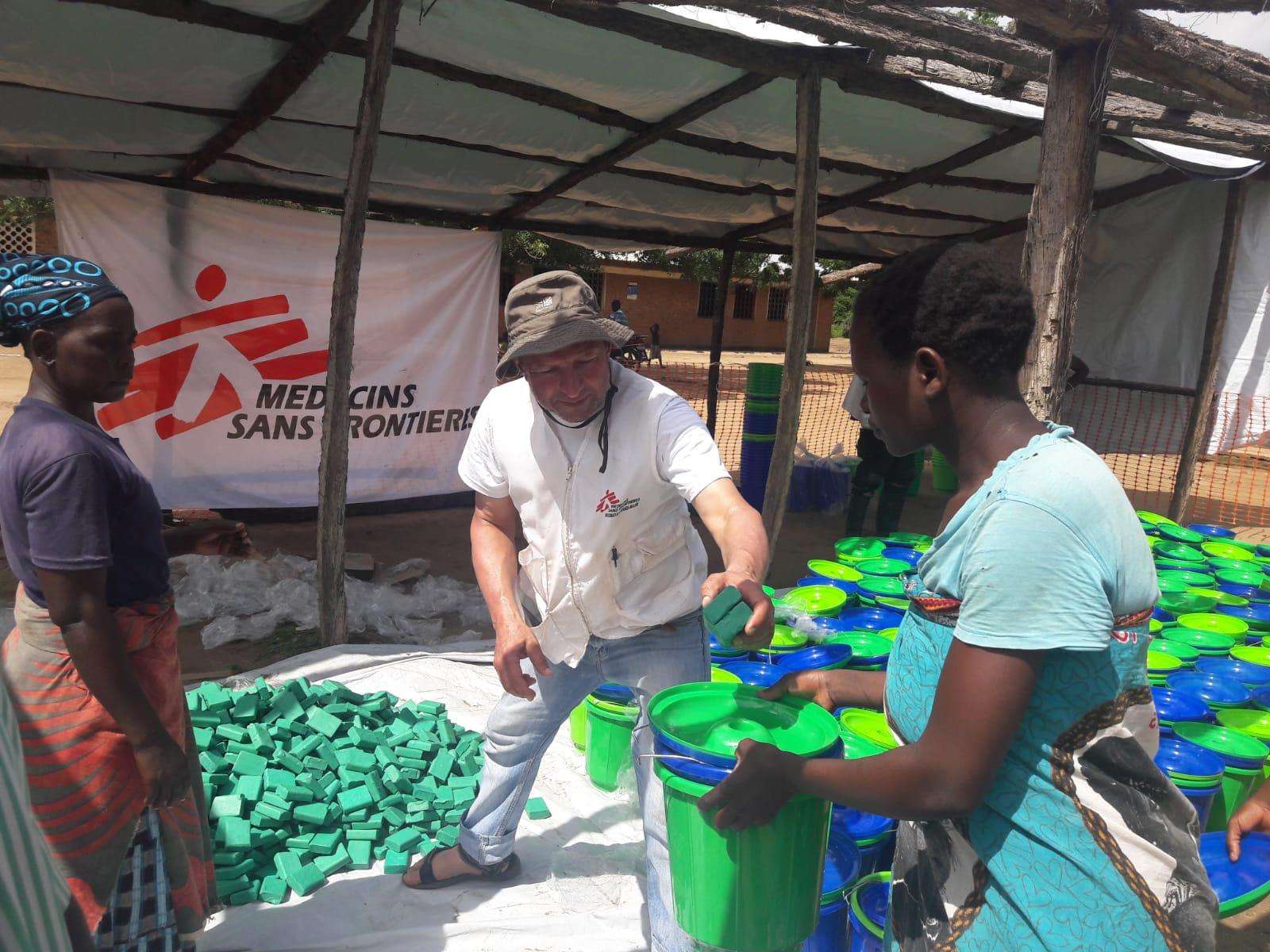 MSF emergency coordinator Said Ayub distributes non-food items including buckets and soap to people affected by the flooding in Makhanga district.