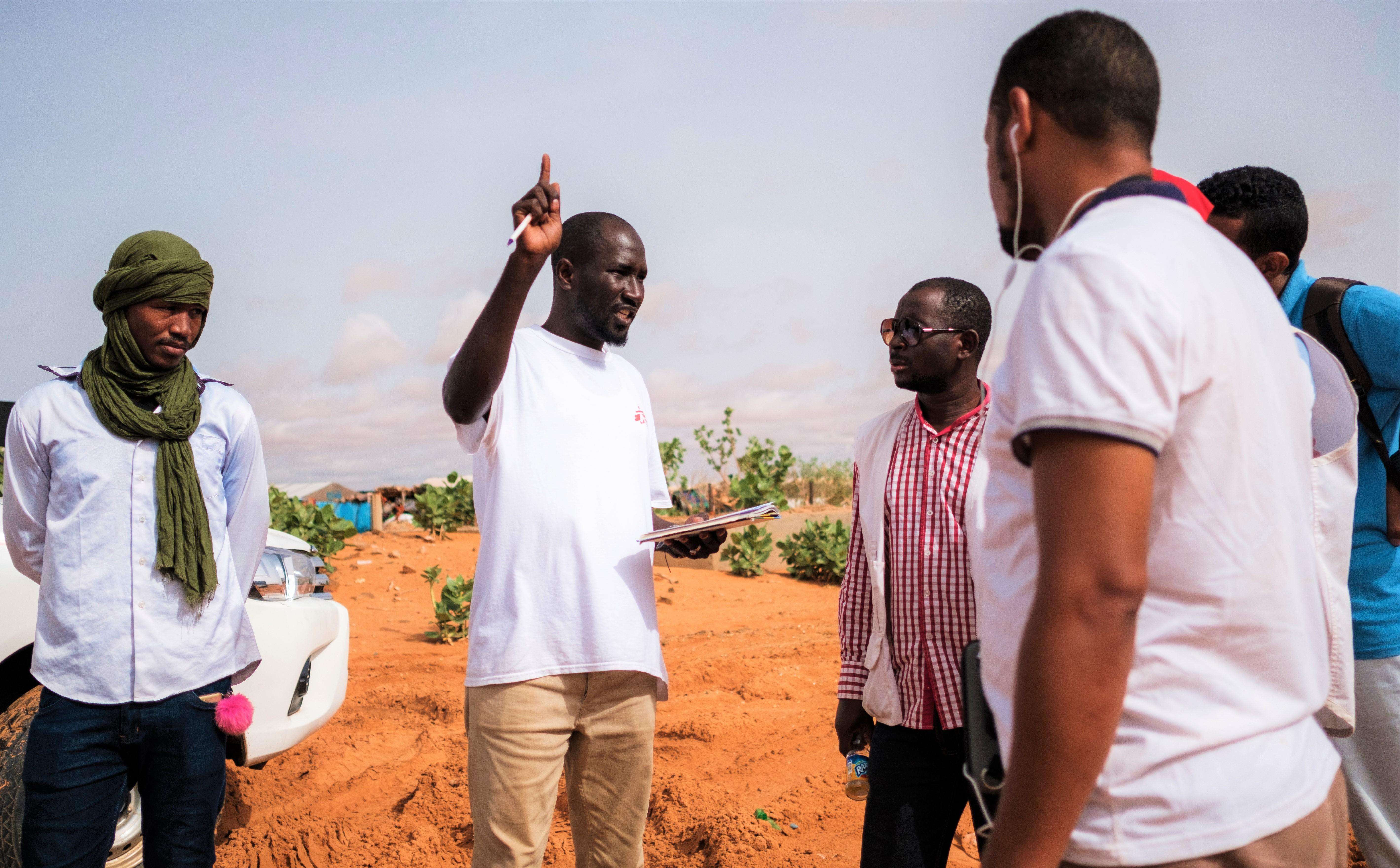 A doctor and Assistant Medical Coordinator briefing vaccination team personnel during a Médecins Sans Frontières (MSF) vaccination campaign in the Mbera refugee camp in southeastern Mauritania.