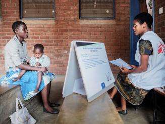 Mary Dyson (left) 23 years, from Nyambiro, sits in counseling room with her son, Harlod Dyson, 23 months old as she takes part in Enhanced Adherence Counseling (EAC) by MSF lay counselor Ruth Chumbu, 27 years in Sorgin Health Center, Nsanje health district.