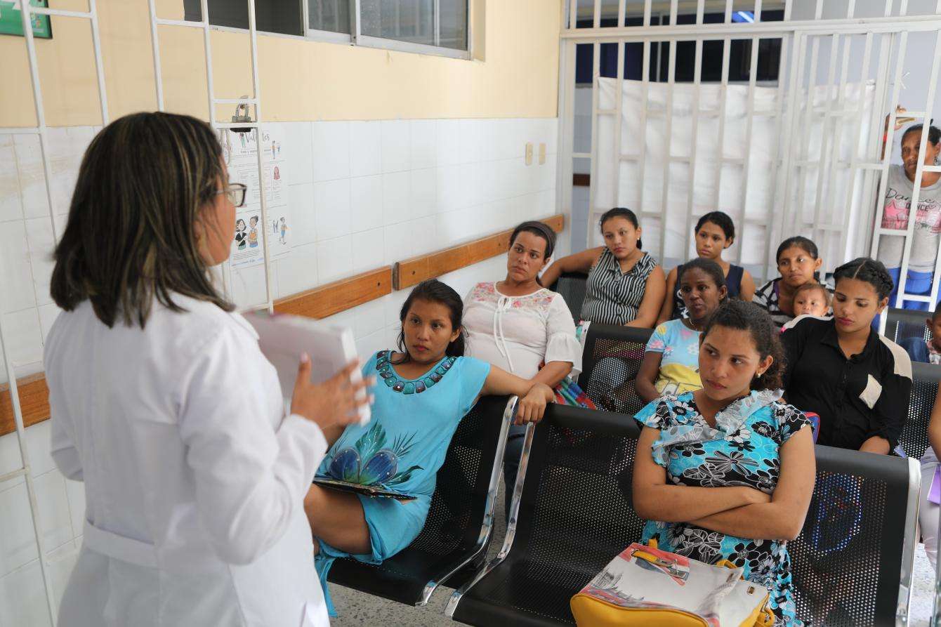 Woman talking to a group of people