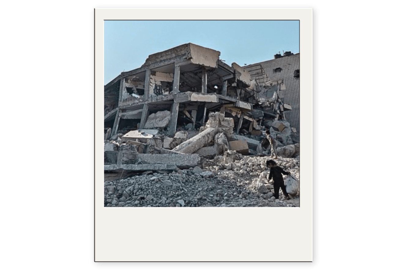 A child in the wreckage of a destroyed building in Gaza.