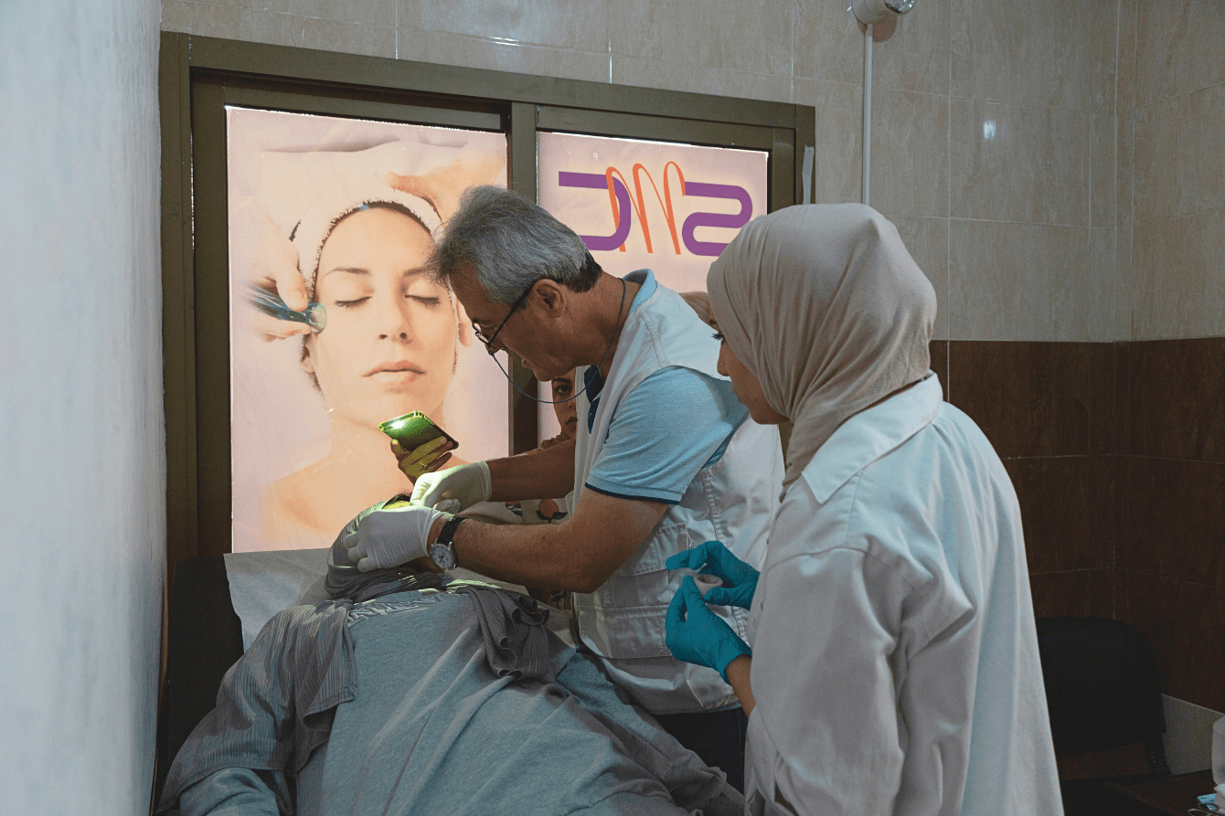 Myassar, a displaced Lebanese woman, has her fractures checked by a doctor.