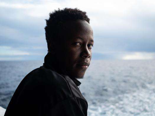 Young man looks out at the Mediterranean sea