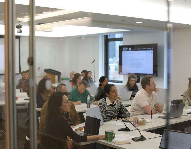 MSF team members sit at tables in a conference room at MSF's US headquarters.