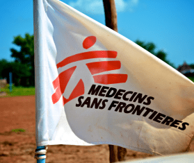 A white flag bearing MSF's logo