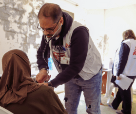 An elderly woman displaced from Lebanon’s south receives care from MSF’s mobile medical unit in a collective shelter near Saida, 35 miles from the southern border in June 2024. 