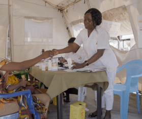 A doctor consults with a patient in Mozambique. 