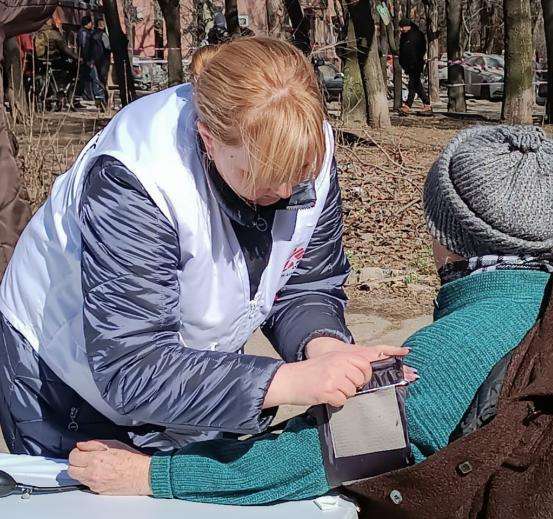 MSF staff taking care of a woman in the residential area hit by a missile on March 02, 2023.