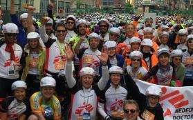 A cycling team celebrates after racing and raising funds for MSF